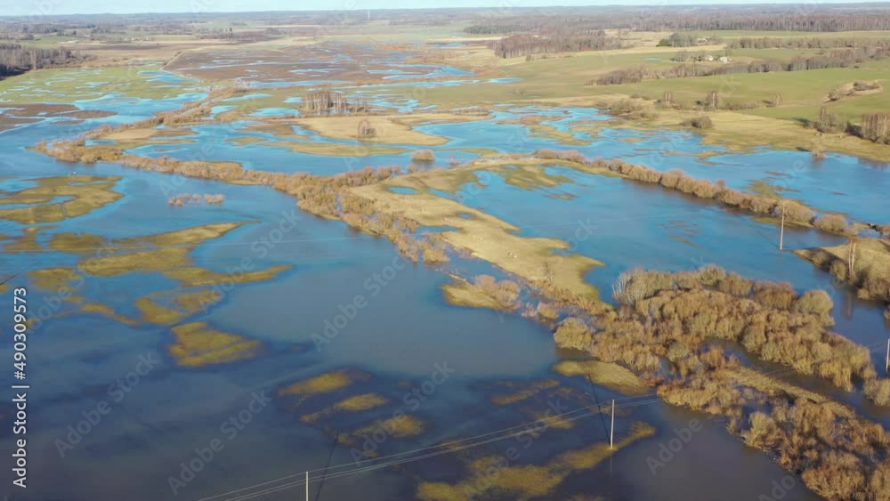 Aerial orbiting shot over flooded fields and meadows