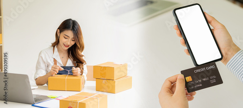 Starting a Small Business, SME Owners, Female Entrepreneurs Work on receipt boxes and check online orders via laptop to prepare boxes. Selling to customers. Online SME business idea.