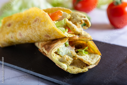 Chicken wrap with salad and tomato. Idea for a tasty and healthy lunch. © Noemi