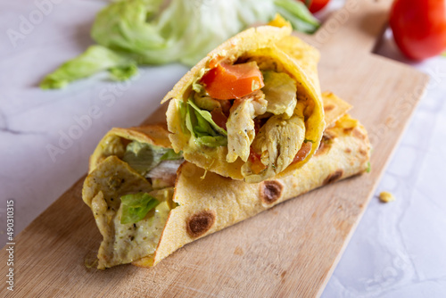 Chicken wrap with salad and tomato. Idea for a tasty and healthy lunch.