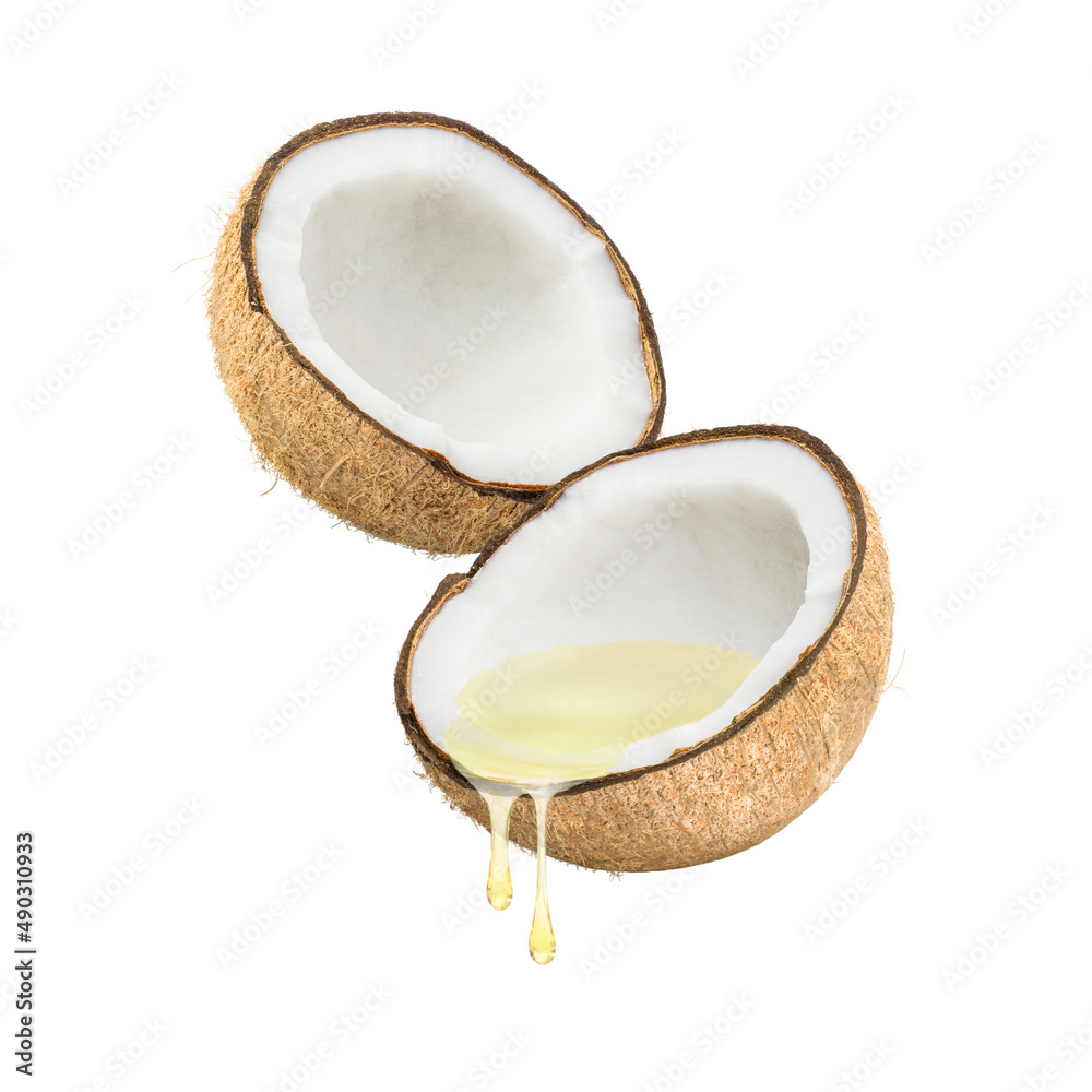 Coconut oil dripping from coconut fruits isolated on white background. Coconut oil dripping from coconut fruits isolated on white background.