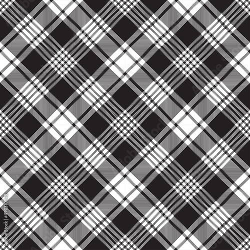 Black and white argyle tartan plaid. Scottish pattern fabric swatch close-up. 