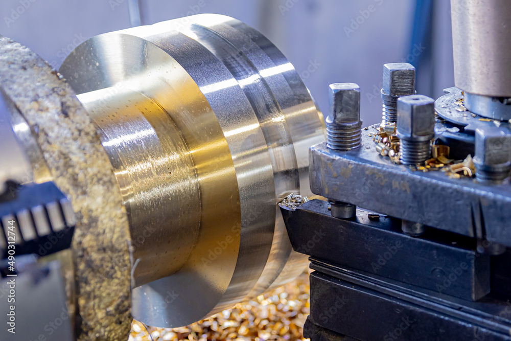 The lathe is in action. Processing of a metal part with a cutter. Metal shavings. Close-up. Soft focus