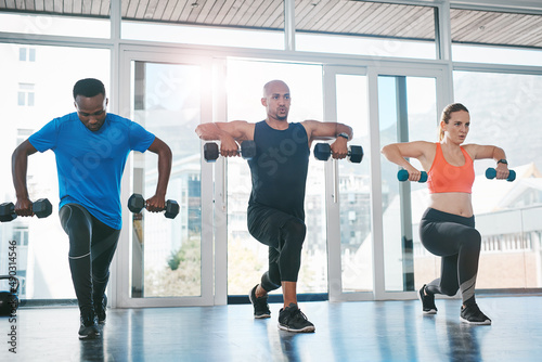 Working out with others makes it easy to stay motivated. Shot of people working out in the gym.