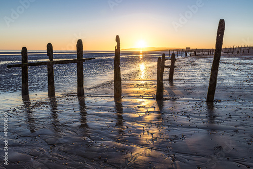 Fototapeta Naklejka Na Ścianę i Meble -  Sunset on the groynes on Rye Harbour beach, East Sussex, England