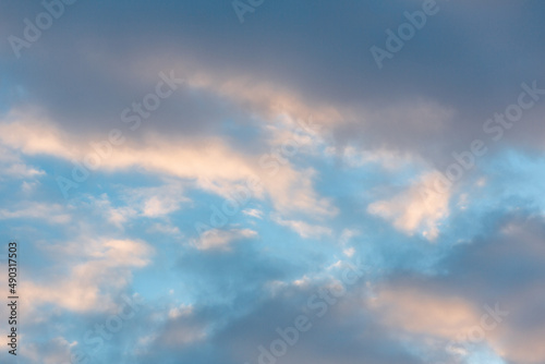 Fototapeta Naklejka Na Ścianę i Meble -  Full frame clouds during a sunset. Orange and teal heavy clouds