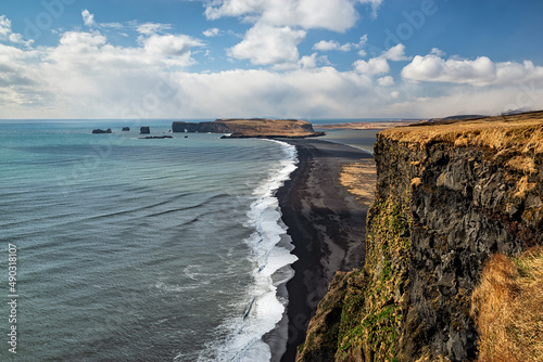 Coastline in Dyrholaey Peninsula in South Iceland in a sunny day photo