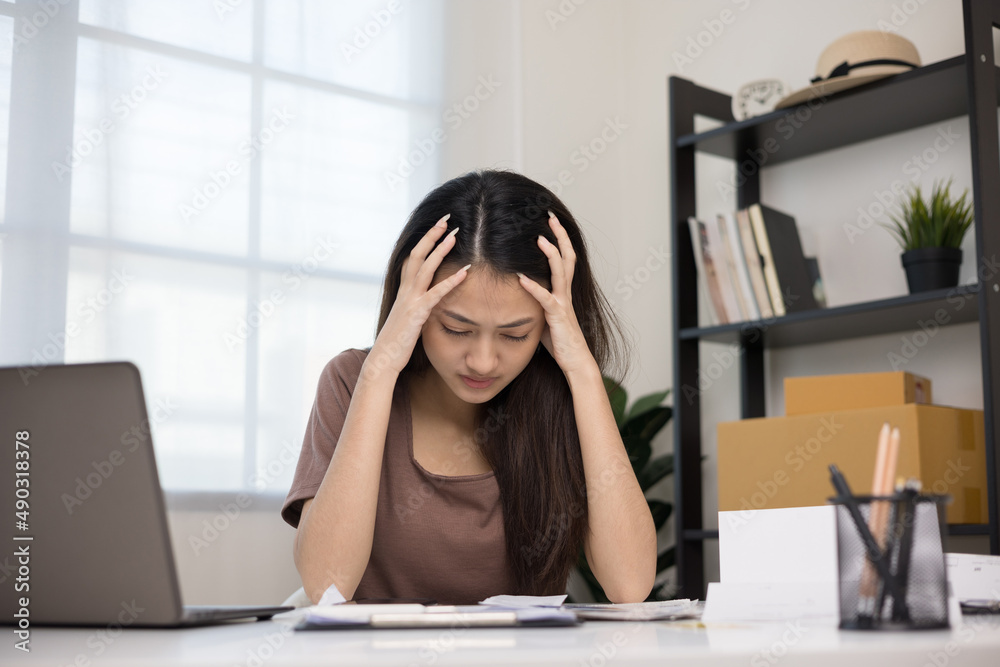 Young asian business woman hand touching head she's feeling depressed stress headache be tired from working with laptop a long time she symptom office syndrome. Young asian business woman hand touching head she's feeling depressed stress headache be tired from working with laptop a long time she symptom office syndrome.