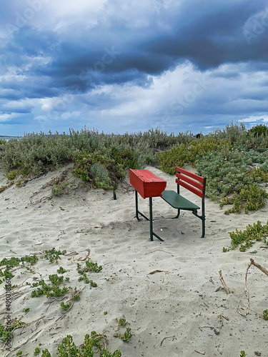 Remote learning . An isolated desk on a beach.