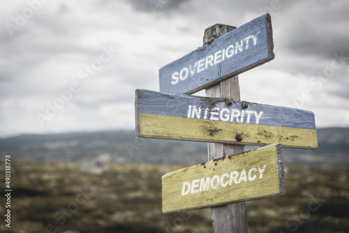 sovereignty integrity democracy text quote on wooden signpost outdoors, written on the ukranian flag.