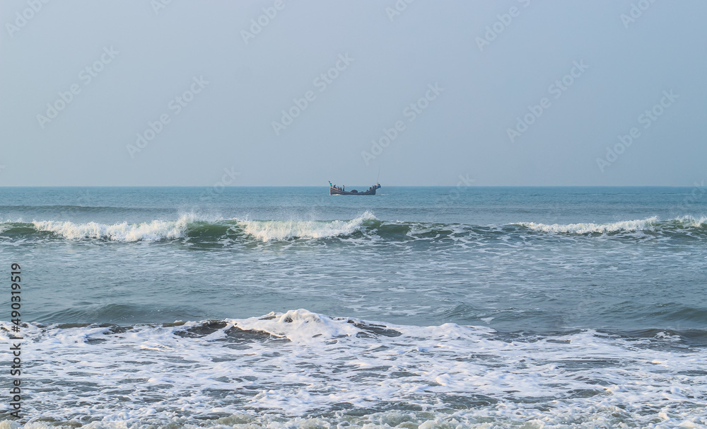 Photo of Industrial fishing boat. Fishing boat in the sea. The fishing industry in India. Indian traditional fishing boat. Photo of Industrial fishing boat. Fishing boat in the sea. The fishing industry in India. Indian traditional fishing boat.