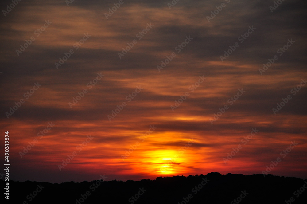 sunset in the clouds. Red sunset sky blow and horizon, nature background.Silhouette sunset with orange sky with clouds at dusk and high space