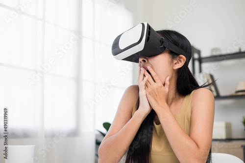 Young asian woman put on vr glasses into virtual simulated world. Future technology digital cyber universe. Person Enjoying an Experiences of Virtual World.
