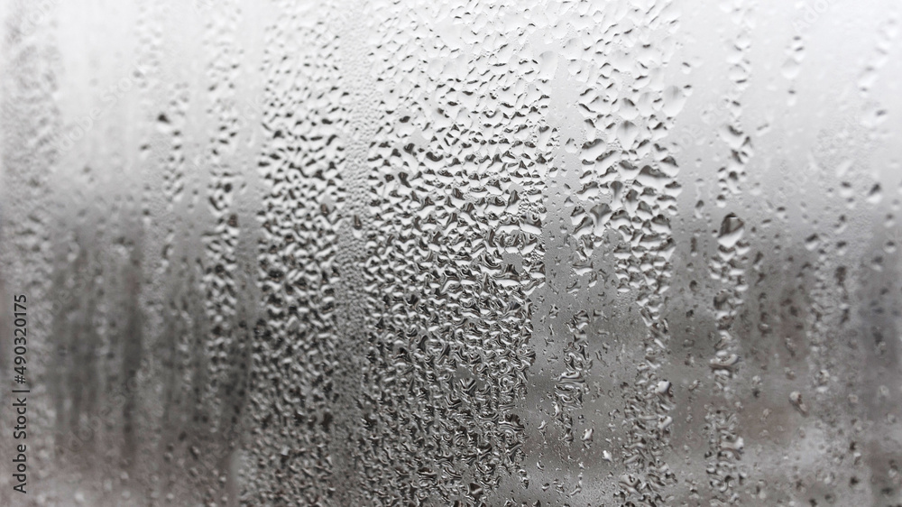 Texture condensation on the glass, outside, bad weather, rain. Steamy window with water drops made in dull day Texture condensation on the glass, outside, bad weather, rain. Steamy window with water drops made in dull day
