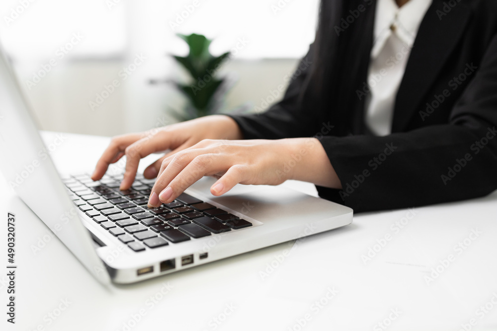 Close up hand woman texting on keyboard laptop work sitting working in office. Close up hand woman texting on keyboard laptop work sitting working in office.