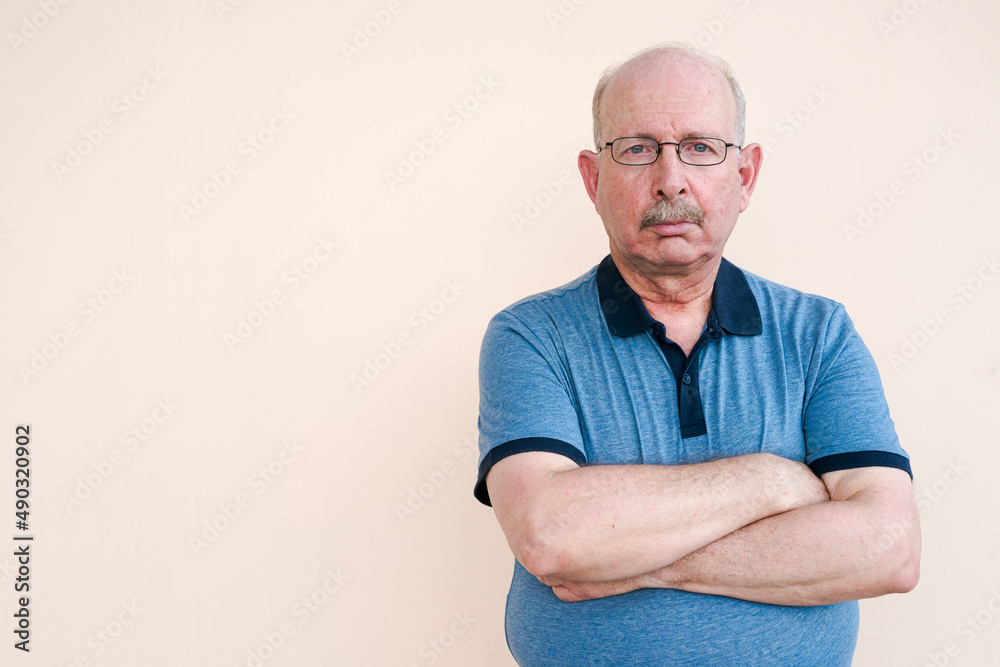 Portrait of senior man looking at camera with arms crossed Portrait of senior man looking at camera with arms crossed