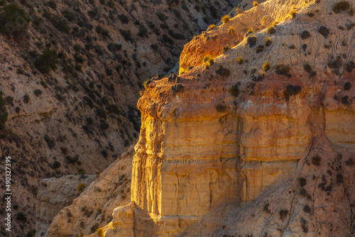 Close up of steep eroded cliffs and badlands of the Gorafe desert, los Coloraos, at sunset Andalusia, Spain,
 photo