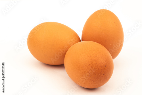 The Netherlands, February 2022. A carton of eggs with feathers on a white background.