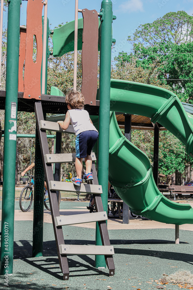 child playing in the playground of moss park in Orlando Florida. Moss