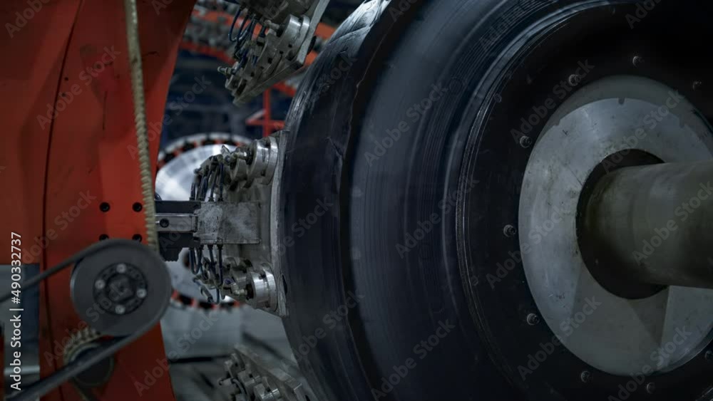 Automated automobile tire production machine with rubber tape at modern factory