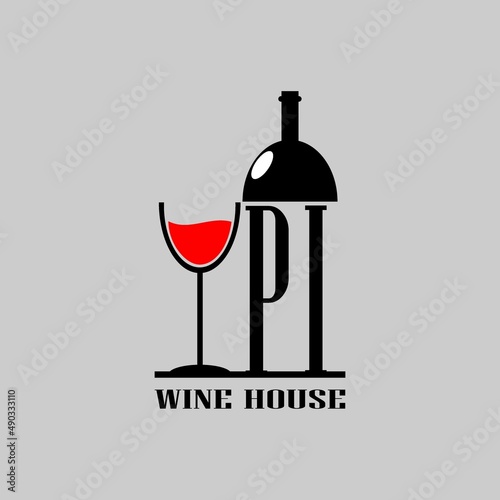 PI letter on wine bottle next to a glass of wine