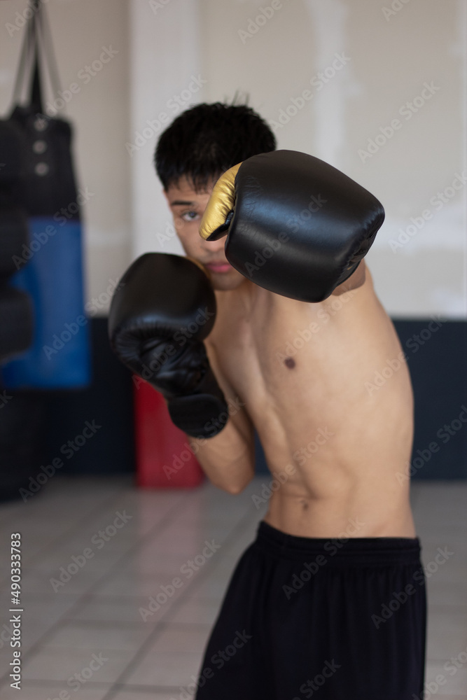 young latin boxer throwing a punch towards the camera young latin boxer throwing a punch towards the camera