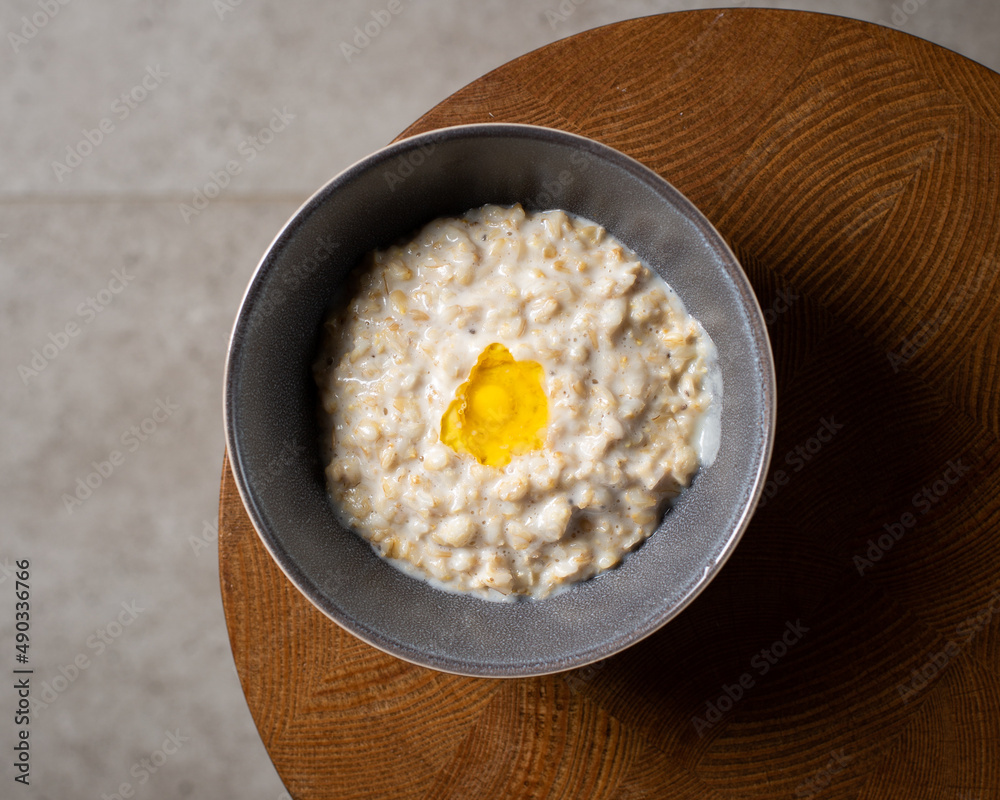 Healthy breakfast oatmeal porridge in bowl. Warm porridge oats, vegan vegetarian weight loss dieting breakfast food Healthy breakfast oatmeal porridge in bowl. Warm porridge oats, vegan vegetarian weight loss dieting breakfast food