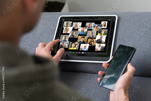 Remote Work Communication. Businesswoman Holding Tablet Having Online Meeting With Group Of Coworkers Making Video Call Via Computer Sitting In Modern Office. Selective Focus, Cropped