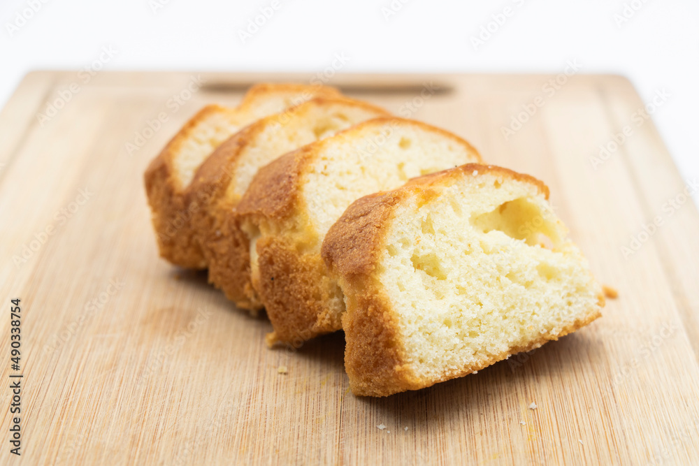 Pound cake on cutting board isolated on white background