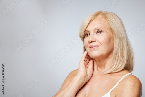 Portrait of beautiful blond senior woman posing and looking away. Beauty photography