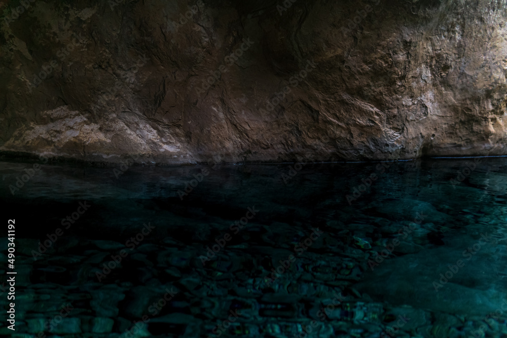 clean underground cave river in steep stone banks in the dark