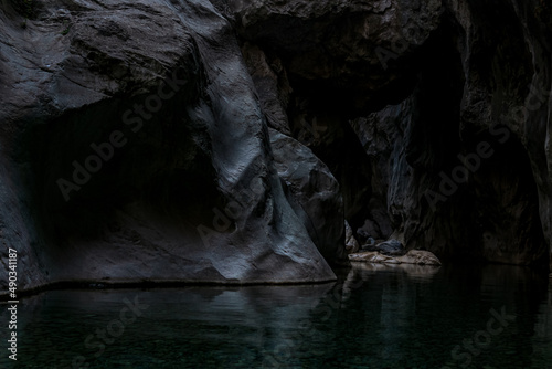 clean underground cave river in steep stone banks in the dark