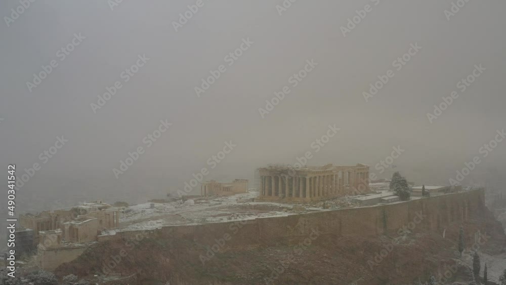 Aerial drone view over the Parthenon and Acropolis hill in middle of a snow storm Aerial drone view over the Parthenon and Acropolis hill in middle of a snow storm