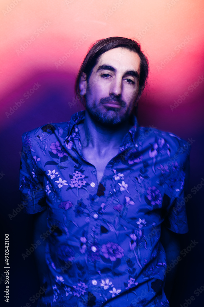 Serious man in studio with glowing light Serious man in studio with glowing light