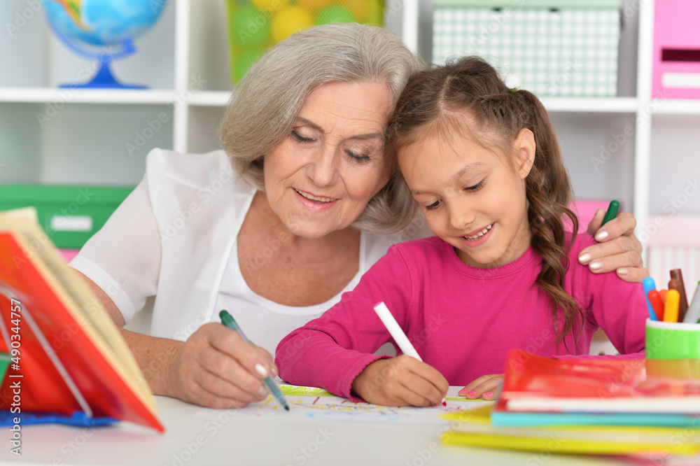 Cute little girl drawing with her grandmother Cute little girl drawing with her grandmother