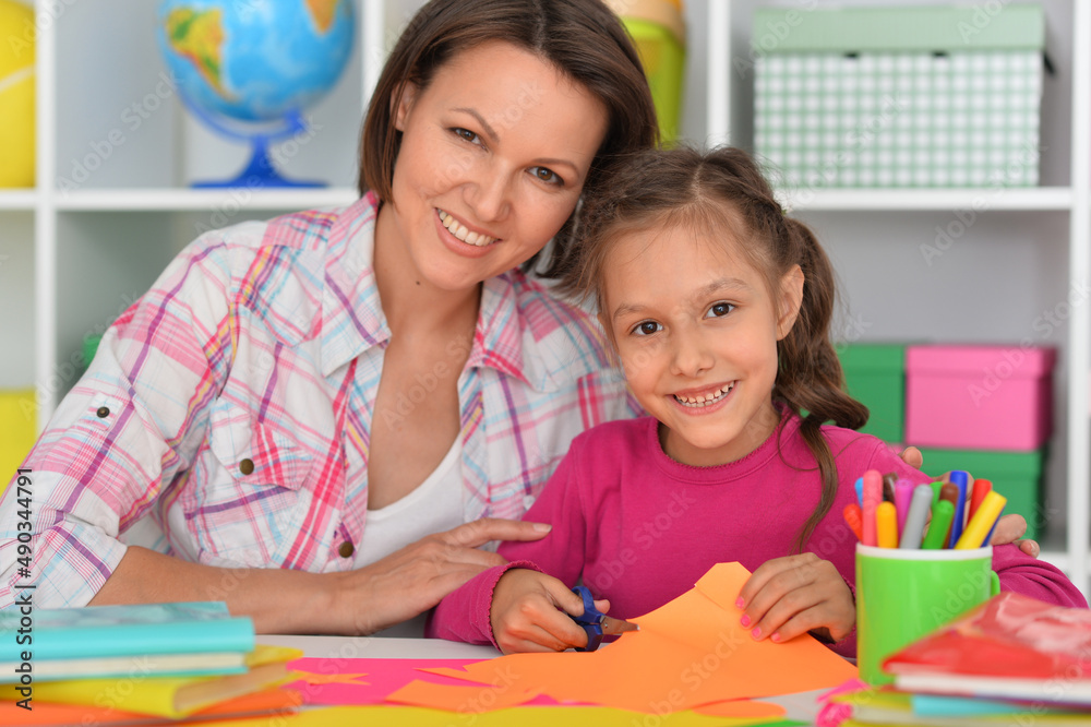 Mother teaches her cute daughter to do craft items Mother teaches her cute daughter to do craft items
