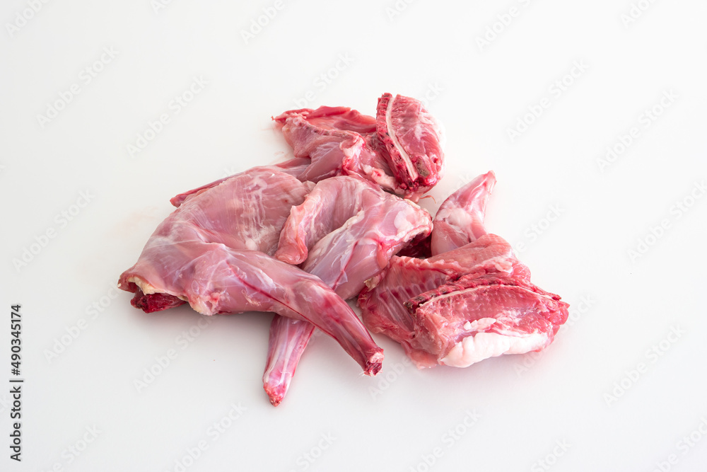 Uncooked raw rabbit or hare legs. Close up top view studio shot, no people