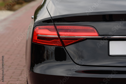 Rear headlight of a car close-up. Business class sedan lighting fixtures. Premium car element. Trunk and exterior details.