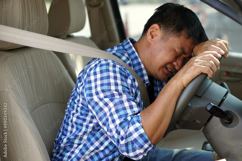 Asian Man Is Sad And Crying In Car His Face Down On The Steering Wheel