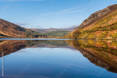 Stunning lake reflections landscape on a crisp and still spring morning at Lough Dan in the Wicklow Mountains in Ireland.