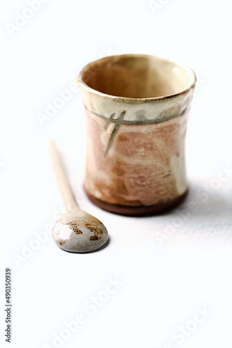 Traditional  handcrafted ceramic on bright wooden background. Soft focus. Close up. 