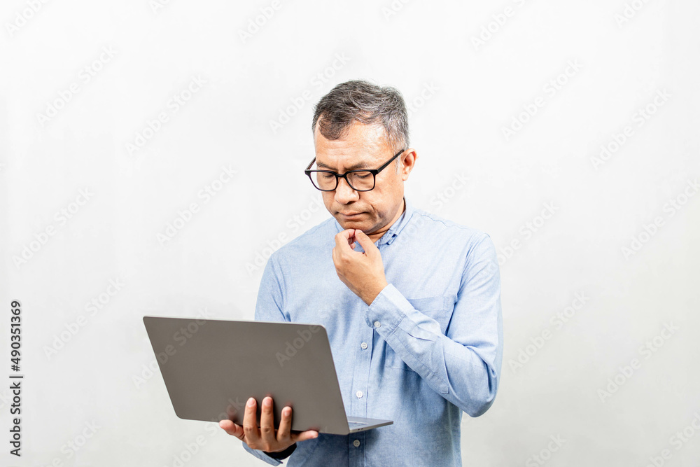 Businessman thinking and analyzing business growth from a laptop computer. Man holding notebook computer and use it. Concept for finance, business operations, real estate, technology, white background Businessman thinking and analyzing business growth from a laptop computer. Man holding notebook computer and use it. Concept for finance, business operations, real estate, technology, white background
