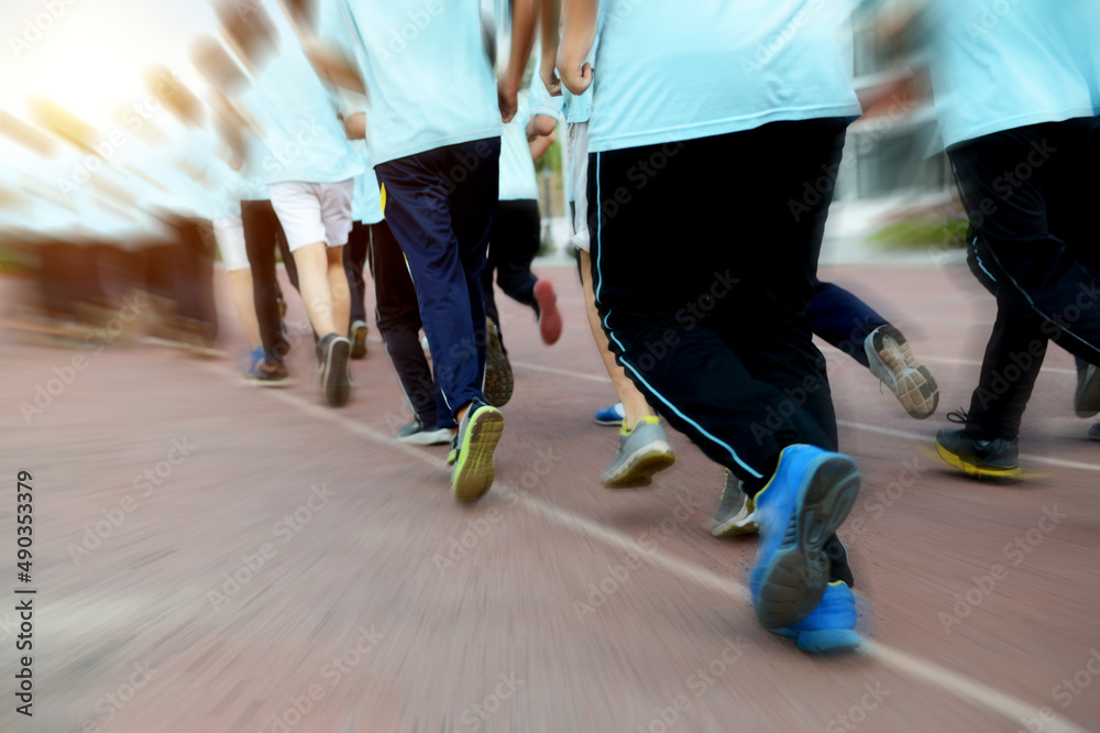 Obraz premium Group of students running on a racing track.