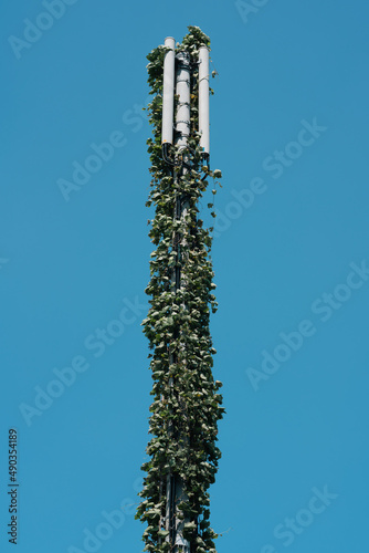 vined radio antenna with blue sky in rural area