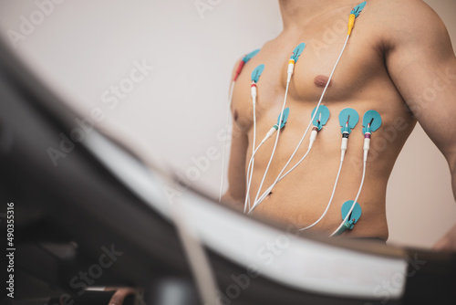 Obraz na plátne A young athlete undergoes a stress test on a treadmill