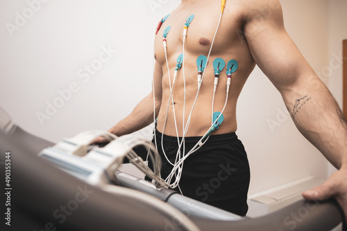 A young athlete undergoes a stress test on a treadmill.It measures the activity of the heart with an electrocardiogram.