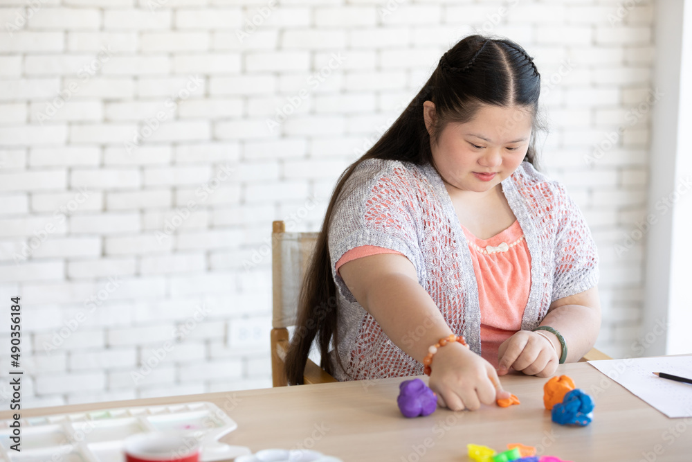 down syndrome girl sculpt plasticine figures on a table down syndrome girl sculpt plasticine figures on a table