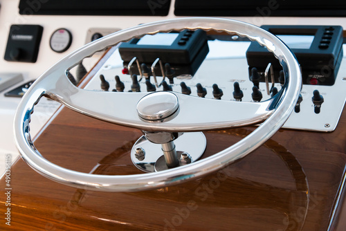 Motor yacht control panel. Steering wheel and gear levers. © Сергей Жмурчак