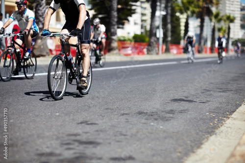 Aiming to win. A group of cyclers out on the road during a cycle tour. © Steele S/peopleimages.com