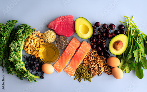 Overhead View of Fresh Omega-3 Rich Foods: A variety of healthy foods like fish, nuts, seeds, fruit, vegetables, and oil rich in omega-3 nutrients photo